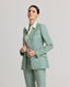 Model wearing the Jackie check tweed jacket in sea green, paired with matching turn-up trousers and Eva Sleeveless Collard Shirt in aqua marine.