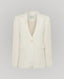Front view of the Elizabeth Linen Jacket in White, a single breasted relaxed fit jacket with under collar melton, contrast orange bottom buttonhole, back vent and white buttons.