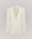 Front view of the Elizabeth Linen Jacket in White, a single breasted relaxed fit jacket with under collar melton, contrast orange bottom buttonhole, back vent and white buttons.