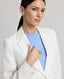 Close-up of model wearing the Elizabeth Linen Jacket in White, featuring its notched lapel.
