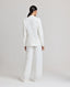 Back view of model wearing the Elizabeth Linen Jacket in White with matching Elizabeth straight relaxed trousers.