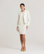 Model wearing Really Wild's cropped Meryl Cute Fitted Jacket In White with the Meryl fitted shift mini dress.
