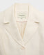 Close up of Really Wild's cropped Meryl Cute Fitted Jacket In White, featuring its notched collar.