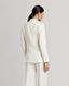 Model back view of the fitted double breasted Corine Stripe Cotton Linen Jacket In Taupe.