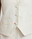 Details of contrast bottom buttonhole, covered buttons and welt pockets of the Meryl Fitted Waistcoat In White.