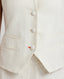 Details of contrast bottom buttonhole, covered buttons and welt pockets of the Meryl Fitted Waistcoat In White.
