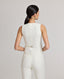 Model back view of the Meryl Fitted Waistcoat In White with the brushed brass buckle in matt silver at the back with adjuster strap.