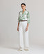 Model wearing the relaxed fit Elizabeth Linen Trousers in White with front pleat detail.