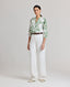 Model wearing the relaxed fit Elizabeth Linen Trousers in White with front pleat detail.