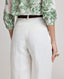 Back view close-up model wearing the relaxed fit Elizabeth Linen Trousers in White, featuring back welt pockets.
