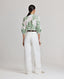 Back view of model wearing the relaxed fit Elizabeth Linen Trousers in White.