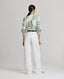 Back view of model wearing the relaxed fit Elizabeth Linen Trousers in White.