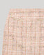 Detail of Cece Boucle Tweed Mini Skirt In Rose Check wide waistband and fringed detail.