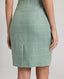 Model wearing the Jackie Wool Silk Shift Dress in sea green—a stand-out dress crafted from a blend of the finest wool, silk, and linen, featuring a simple structure and bold sea green colour, perfect for all occasions and transitioning seamlessly throughout the seasons. Detailed view of the back vent detail.