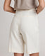 Back view of model wearing the Corine Tailored Stripe Shorts in Taupe.