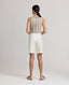 Back view of model wearing the Corine Tailored Stripe Shorts in Taupe.