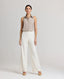 Model wearing the relaxed fit Corine Stripe Linen Trousers In Taupe.