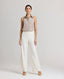 Model wearing the relaxed fit Corine Stripe Linen Trousers In Taupe.
