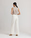 Back view of model wearing the relaxed fit Corine Stripe Linen Trousers In Taupe.