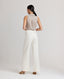 Back view of model wearing the relaxed fit Corine Stripe Linen Trousers In Taupe.