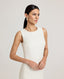 Close up of a model wearing the Meryl Shift Dress in White - a fitted mini dress with a clean neckline, invisible zip and princess seams.