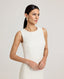 Close up of a model wearing the Meryl Shift Dress in White - a fitted mini dress with a clean neckline, invisible zip and princess seams.