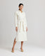 Model wearing the Meryl Shirt Dress In White. Midi length utility dress with patch pockets.