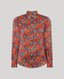 Sidney Paisley Liberty Silk Shirt in fiery orange-red—a 100% silk satin shirt featuring a paisley pattern, designed to elevate both country and city looks. Pair it with tailored trousers for a refined, office-ready ensemble, or dress down with jeans for a relaxed look. Front view.