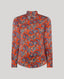Sidney Paisley Liberty Silk Shirt in fiery orange-red—a 100% silk satin shirt featuring a paisley pattern, designed to elevate both country and city looks. Pair it with tailored trousers for a refined, office-ready ensemble, or dress down with jeans for a relaxed look. Front view.