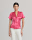 Front view of model wearing the Celeste Tie Neck Liberty Silk Top In Coral. A V-neck blouse with tulip sleeves and a detachable 175cm tie at neck, covered buttons.