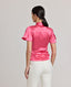 Back view of model wearing the Celeste Tie Neck Liberty Silk Top In Coral with tulip sleeves.