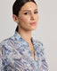 Neckline detail view of model wearing the relaxed Sophia shirt in blue made from 100% Liberty silk chiffon.