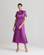 Model wearing the Nicole Liberty Silk Tie Neck Dress In Amethyst with detachable neck tie.