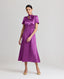 Model wearing the Nicole Liberty Silk Tie Neck Dress In Amethyst with detachable neck tie.