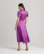 Back view of model wearing the Nicole Liberty Silk Tie Neck Dress In Amethyst with detachable neck tie.