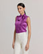 Model wearing the Nicole Liberty Silk Tie Neck Blouse In Amethyst. A sleeveless blouse with detachable tie at neck, bound armholes and pleat details at front.