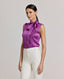 Model wearing the Nicole Liberty Silk Tie Neck Blouse In Amethyst. A sleeveless blouse with detachable tie at neck, bound armholes and pleat details at front.