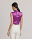 Back view of Model wearing the Nicole Liberty Silk Tie Neck Blouse In Amethyst. Showcasing a keyhole back opening with covered buttons, bound armholes and back waist darts for shaping.