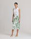 Model Wearing the Ella Tie Skirt in Tropical Green. This high waisted midi Wrap skirt comes with a side tie and internal button.