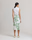 Back view of model Wearing the Ella Tie Skirt in Tropical Green. This high waisted midi Wrap skirt comes with a side tie and internal button.
