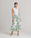 Model wearing the Flora Full A-line Midi Skirt In Tropical Green with invisible zip at back and side pockets.