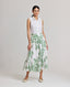 Model wearing the Flora Full A-line Midi Skirt In Tropical Green with invisible zip at back and side pockets.