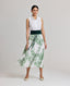 Model wearing the Flora Full A-line Midi Skirt In Tropical Green with the Eva Sleeveless Collard Blouse and Forest Green Cummerbund.