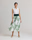 Model wearing the Flora Full A-line Midi Skirt In Tropical Green with the Eva Sleeveless Collard Blouse and Forest Green Cummerbund.
