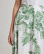 Close-up of model wearing the Flora Full A-line Midi Skirt In Tropical Green.