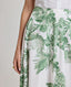 Close-up of model wearing the Flora Full A-line Midi Skirt In Tropical Green.