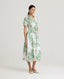 Model wearing the Ella Shirt Dress in Tropical Green. This dress has folded cap sleeves, concealed placket with mother of pearl buttons, hidden pockets at the side seams and comes with a tubular belt in same Tropical Green fabric.