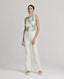 Model wearing the Flora Tie Neck Blouse In Tropical Green, with the Elizabeth Linen Trousers in White.
