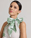 Close-up of model wearing the Flora Tie Neck Blouse In Tropical Green, featuring the halterneck tie in a bow.