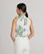 Back view of model wearing the Flora Tie Neck Blouse In Tropical Green, featuring the keyhole opening and covered buttons at the back.